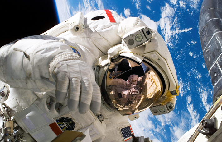 Astronaut in space with gold visor